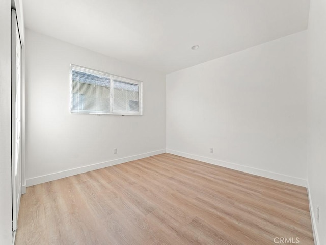 spare room with light wood-type flooring