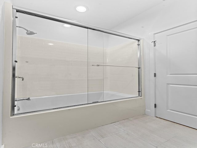 bathroom with enclosed tub / shower combo and tile patterned flooring