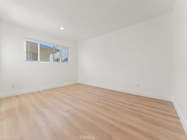 spare room with light hardwood / wood-style flooring