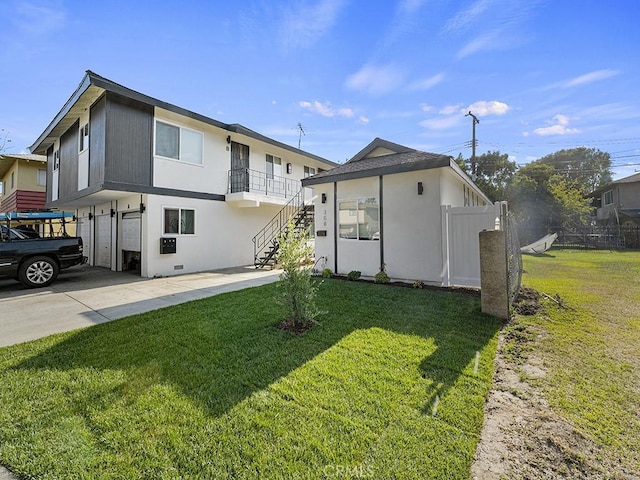 rear view of property with a yard and a garage