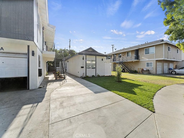 exterior space featuring a garage and a front lawn