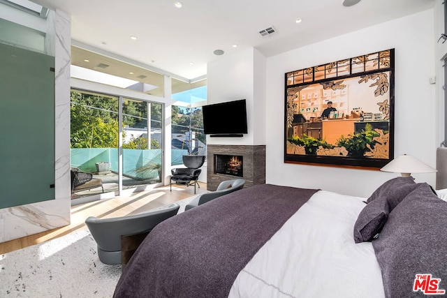 bedroom featuring access to exterior and wood-type flooring