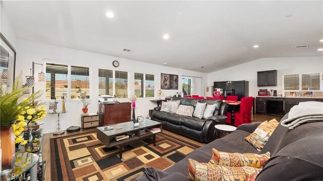 living room with dark hardwood / wood-style flooring and lofted ceiling