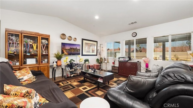 living area with lofted ceiling and visible vents