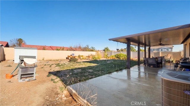 view of yard featuring ceiling fan, a patio, central AC unit, and a fenced backyard