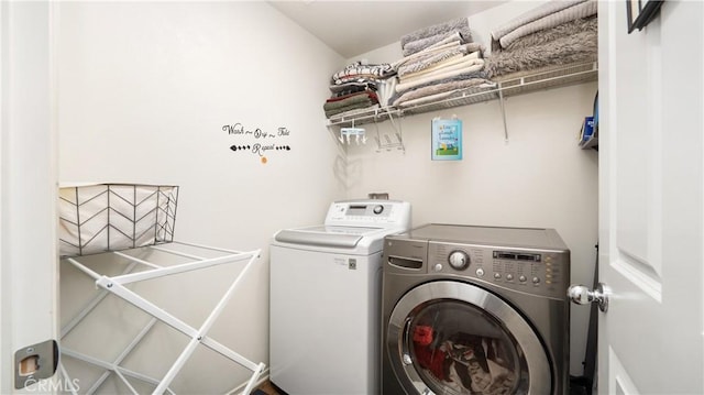 clothes washing area featuring washing machine and dryer and laundry area