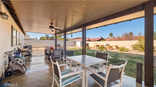 view of patio / terrace with a fenced backyard, outdoor dining area, and a ceiling fan