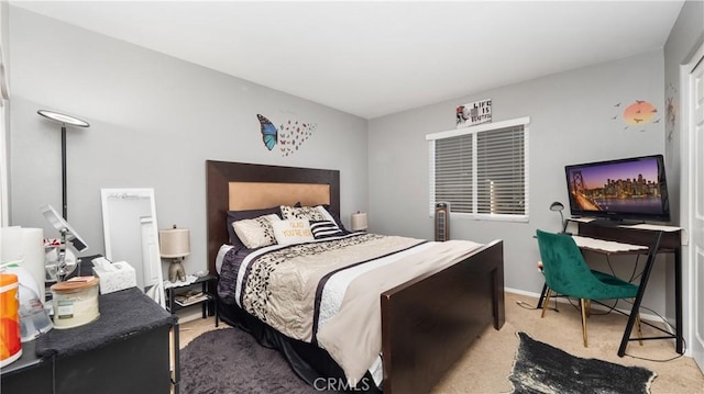 bedroom with light carpet and baseboards