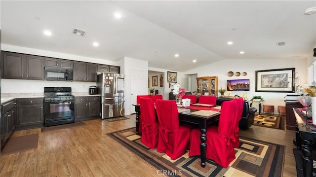 dining area with lofted ceiling, light wood-style flooring, visible vents, and recessed lighting