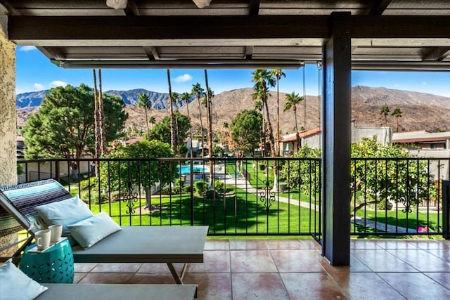 balcony featuring ceiling fan and a mountain view