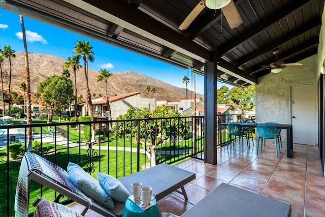 balcony with a mountain view and ceiling fan