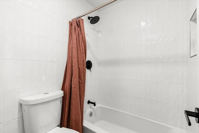 bathroom featuring tile walls, toilet, and shower / bathtub combination with curtain