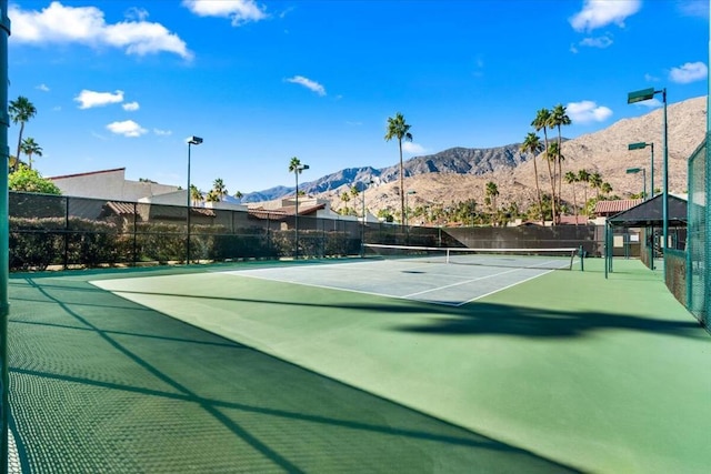 view of sport court featuring a mountain view and basketball hoop