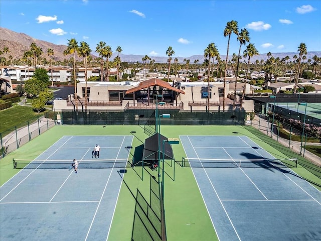 view of tennis court featuring a mountain view and basketball court