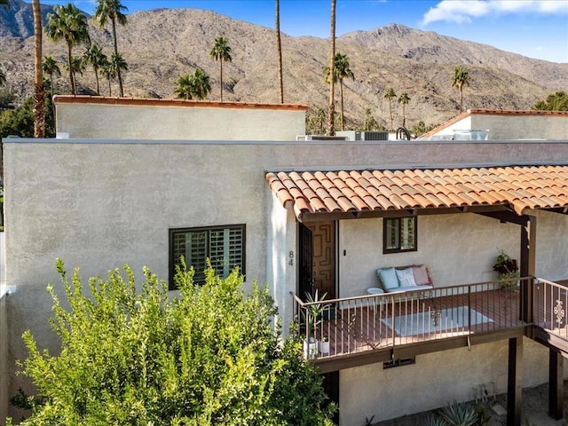 rear view of house featuring a mountain view