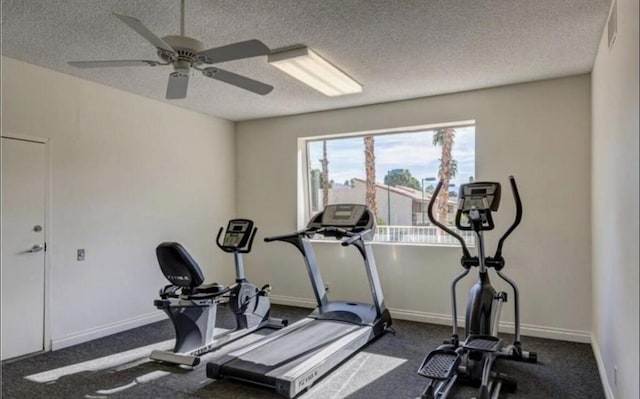 exercise area featuring ceiling fan and a textured ceiling