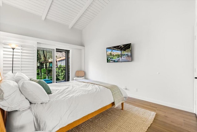 bedroom with access to outside, vaulted ceiling with beams, hardwood / wood-style flooring, and wooden ceiling