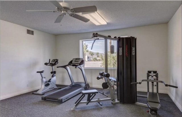 exercise area with a textured ceiling and ceiling fan