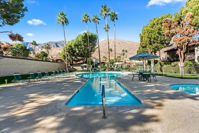 view of pool featuring a mountain view and a patio area