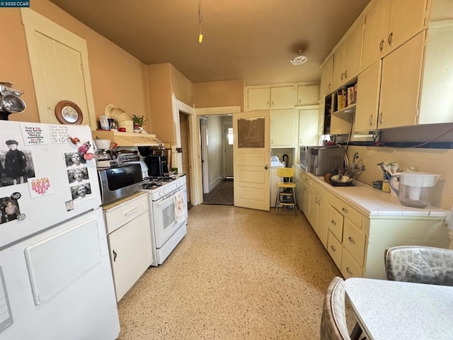 kitchen featuring white appliances and tasteful backsplash