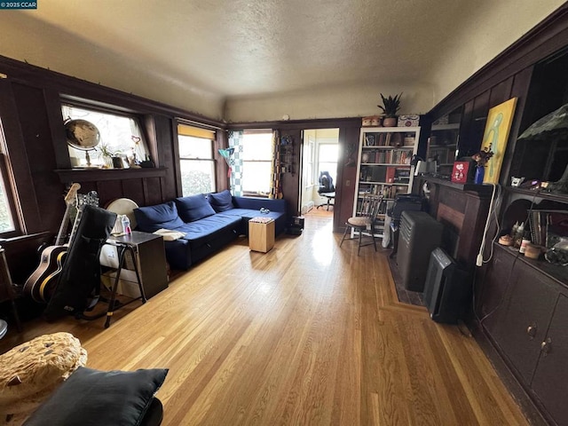 living room with wood-type flooring and a textured ceiling