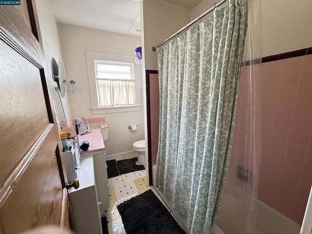 bathroom featuring toilet, vanity, tile walls, and curtained shower