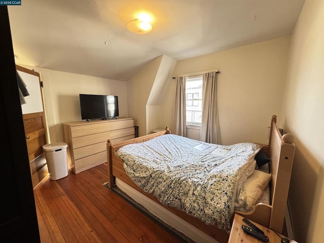 bedroom with dark hardwood / wood-style floors