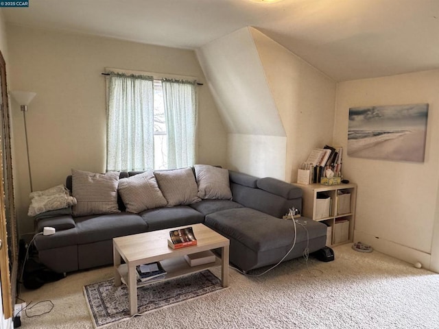 living room featuring vaulted ceiling and carpet flooring