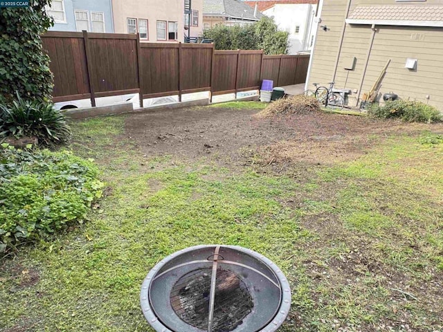 view of yard with a fire pit