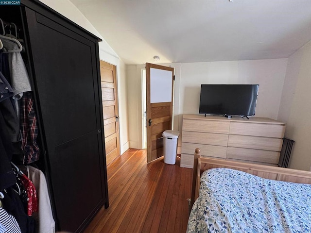 bedroom featuring lofted ceiling and dark hardwood / wood-style flooring