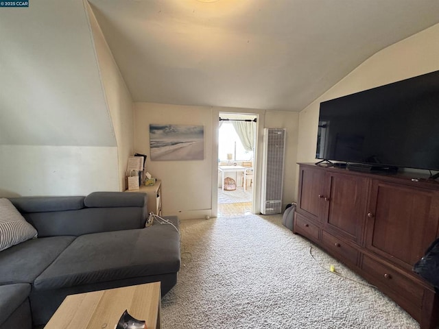 carpeted living room featuring vaulted ceiling