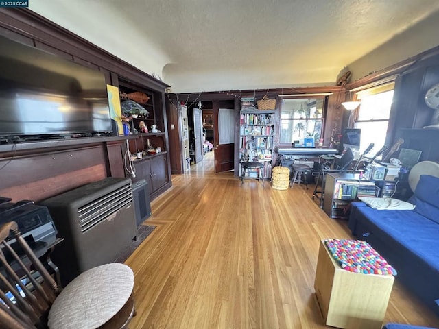 living room featuring a textured ceiling and light wood-type flooring