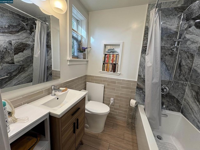 full bathroom featuring toilet, tile walls, shower / bath combo, and vanity