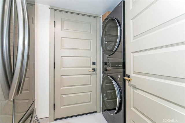 washroom featuring stacked washing maching and dryer