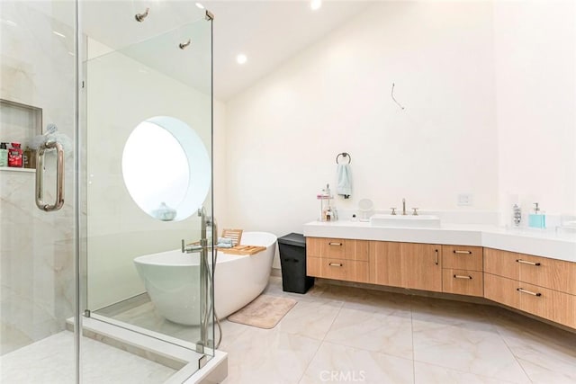 bathroom with plus walk in shower, lofted ceiling, and vanity