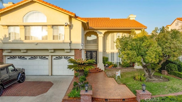 mediterranean / spanish-style home featuring a garage