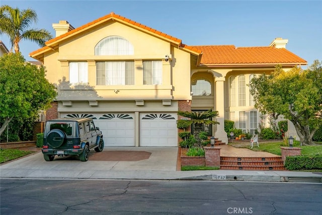 mediterranean / spanish-style house featuring a garage