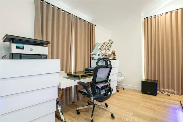 home office with crown molding and light wood-type flooring