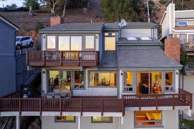 rear view of property with a balcony