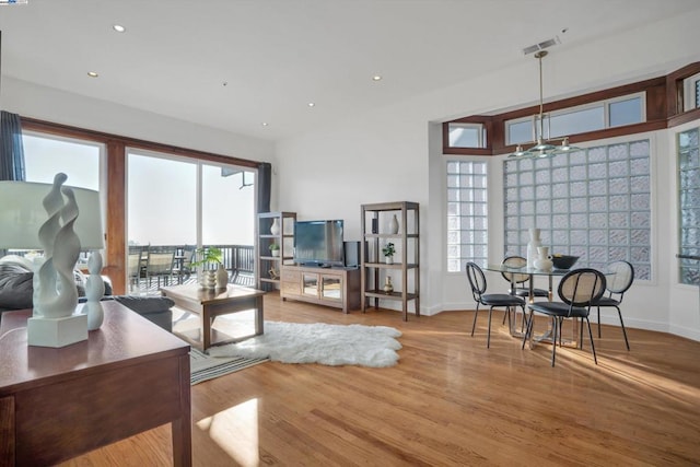 living room featuring ceiling fan and hardwood / wood-style floors