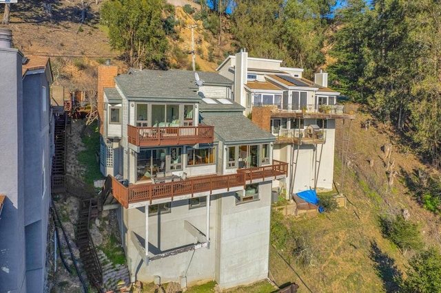 rear view of property with a balcony