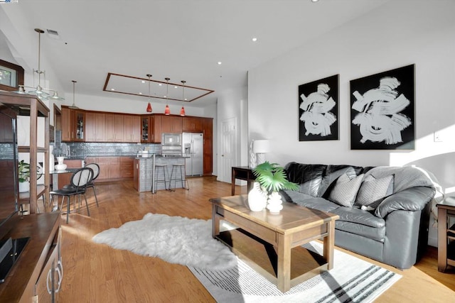 living room with ceiling fan and light hardwood / wood-style flooring