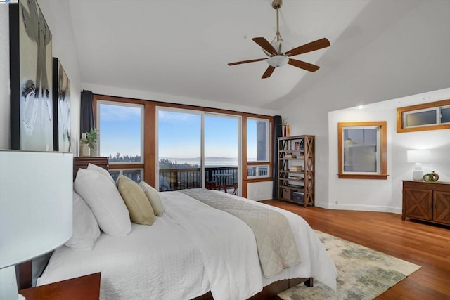 bedroom featuring ceiling fan, access to exterior, hardwood / wood-style flooring, and high vaulted ceiling