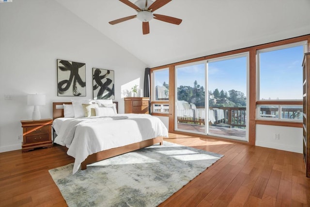 bedroom with ceiling fan, access to exterior, hardwood / wood-style flooring, and lofted ceiling