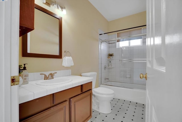 full bathroom featuring toilet, vanity, and tiled shower / bath combo