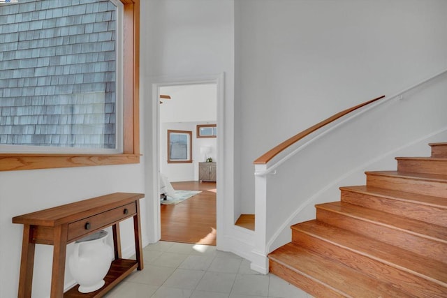 stairway with tile patterned floors