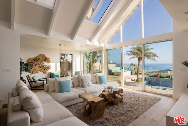 living room with light hardwood / wood-style floors, a water view, high vaulted ceiling, and beamed ceiling