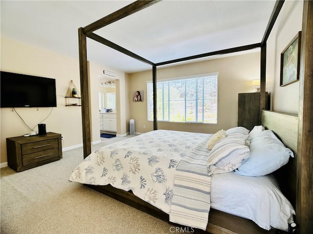 carpeted bedroom featuring ensuite bath