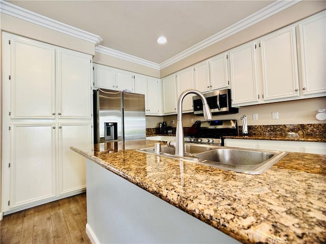 kitchen featuring white cabinetry, crown molding, stainless steel appliances, light stone countertops, and light hardwood / wood-style floors