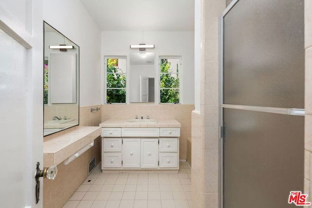 bathroom featuring tasteful backsplash, vanity, and tile patterned flooring